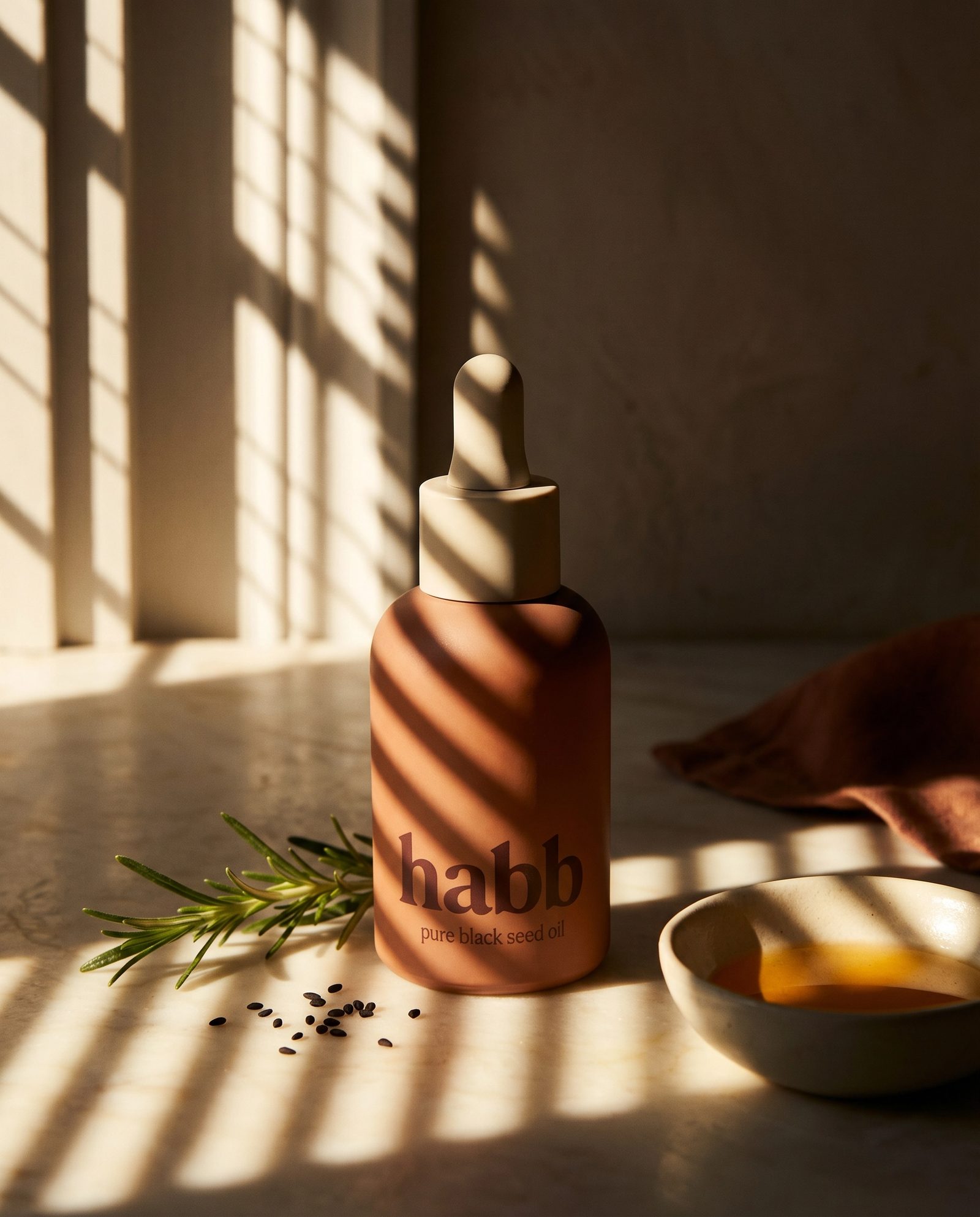 habb terracotta bottle on cream marble with warm shadow play in soft morning light